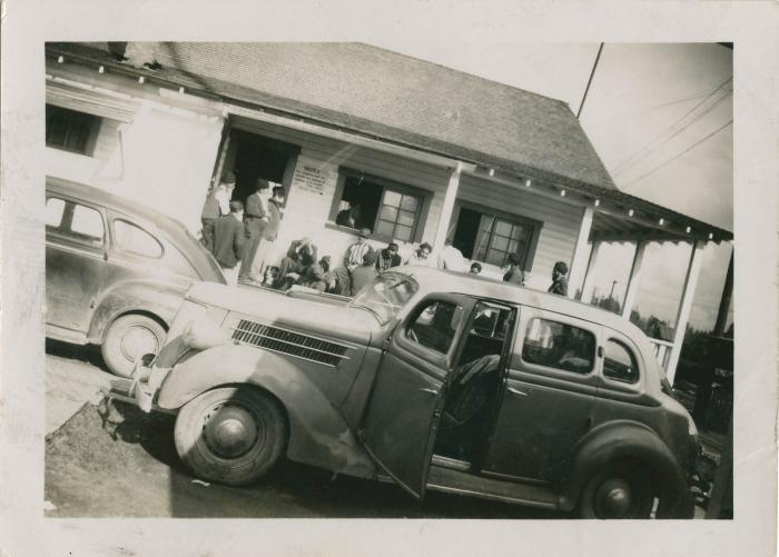 [Cars and men gathered outside of the Mayo Lumber Co. cookhouse]
