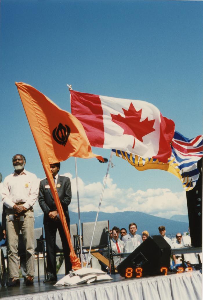 Flags on stage at the Canada Place gathering