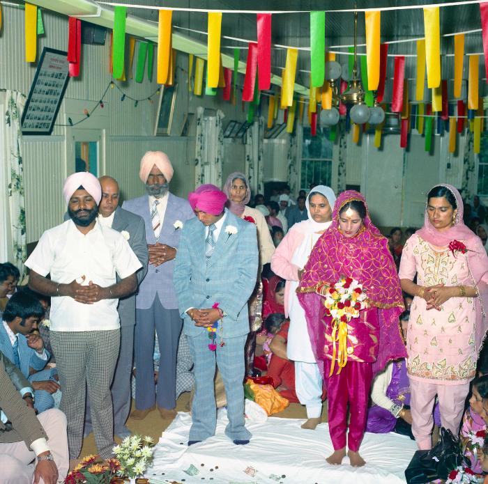[Photo of Baldave Sidhu, Sharn Kingra and weddings guests]