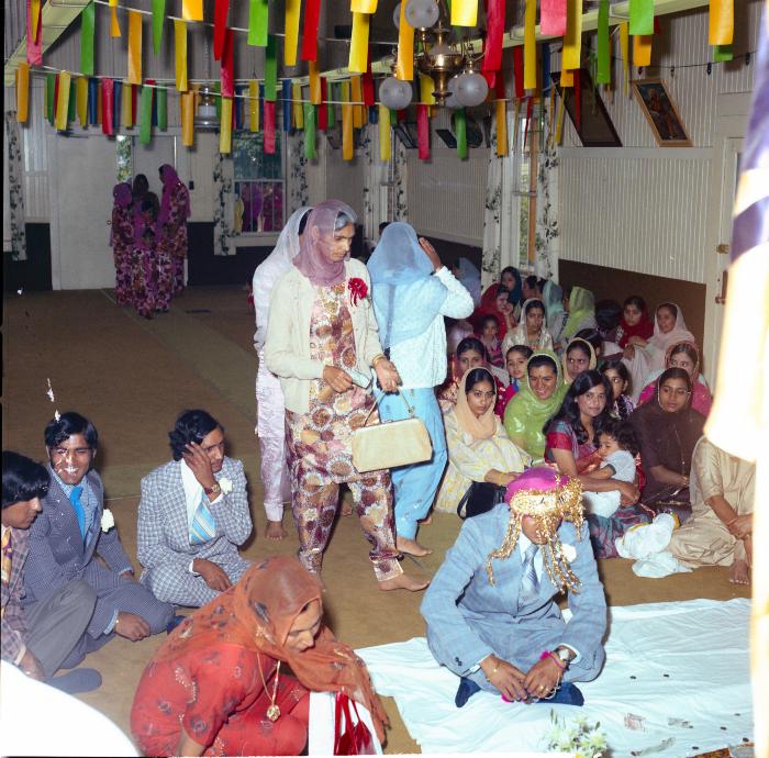 [Photo of Baldave Sidhu and weddings guests]