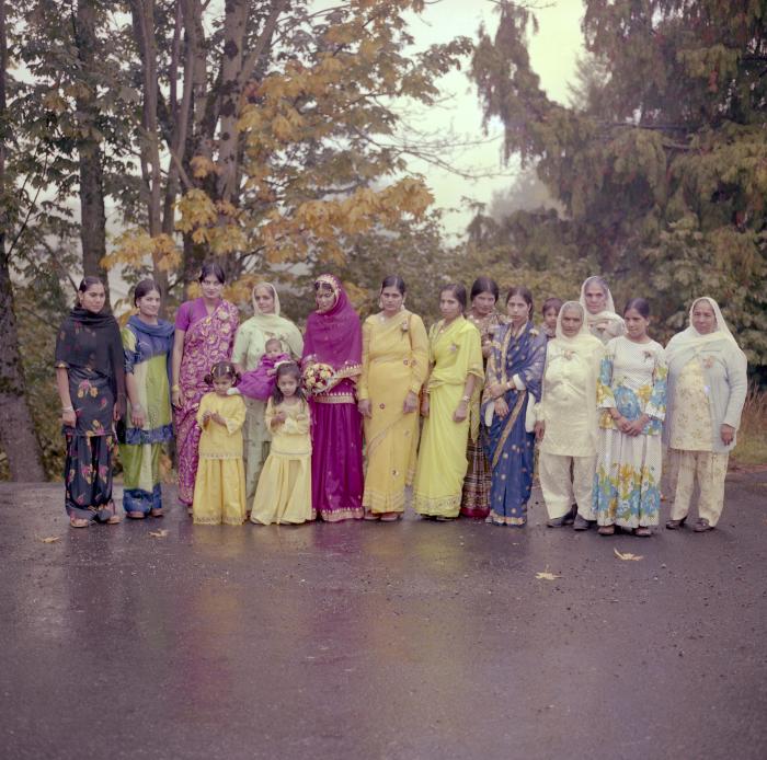 [Photo of Chindo Sidhu and a group of unidentified women]