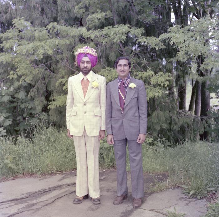 [Photo of Sinder Sandhu and an unidentified man]