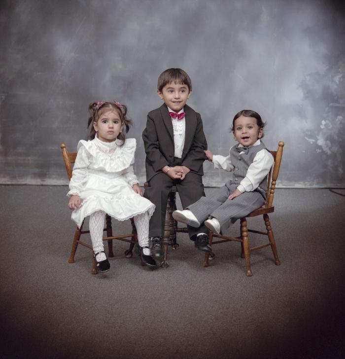 [Group portrait of three unidentified children]