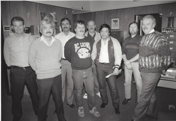 [Group photo of Harry Bains and unidentified IWA executives]