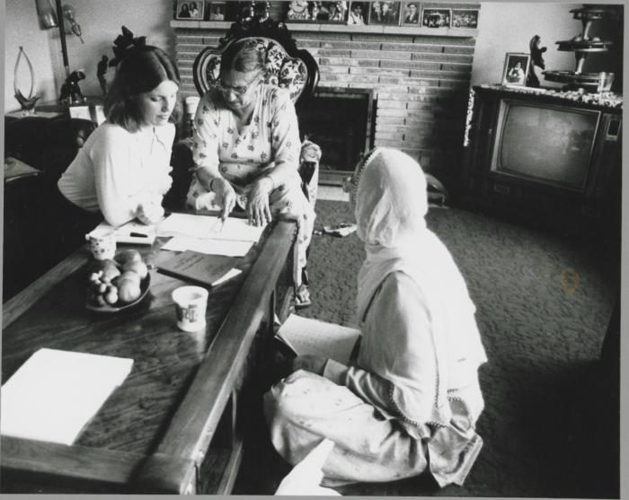 [Photo of unidentified women in discussion]