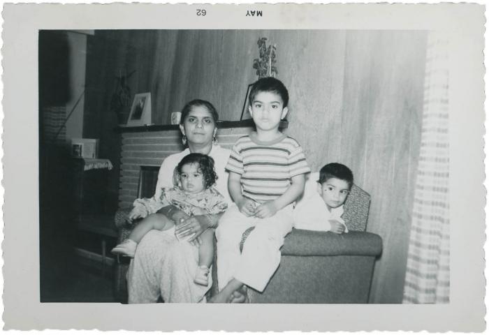 [Photo of Gurmail Singh Gill sitting with his siblings and his mother]