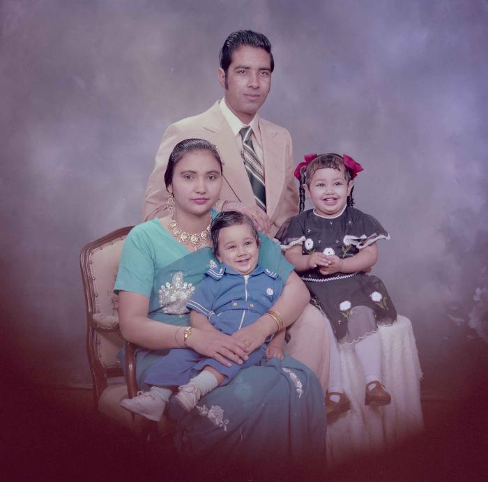 [Photo of Hardev Sandhu with family members]