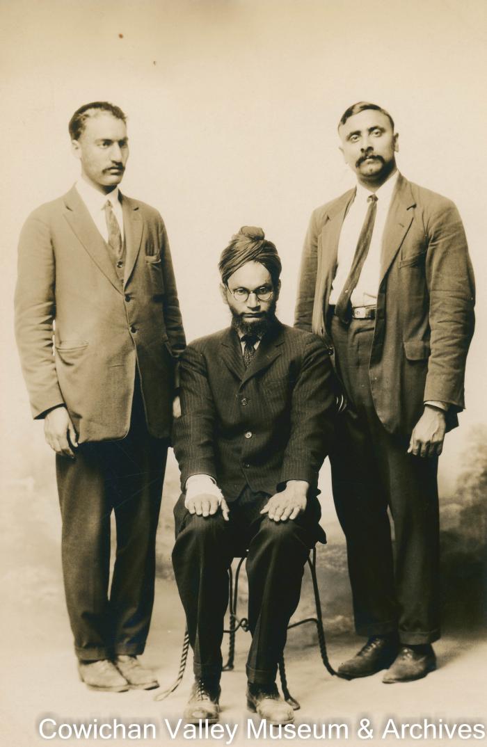 [Three men posing for a group photo]