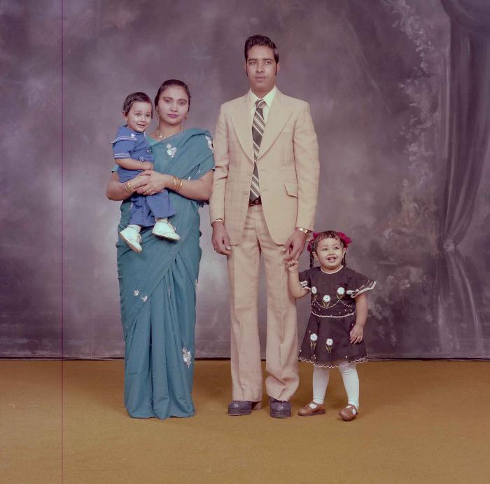 [Photo of Hardev Sandhu with family members]