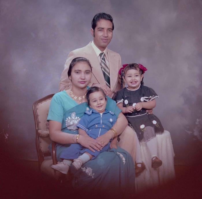 [Photo of Hardev Sandhu with family members]