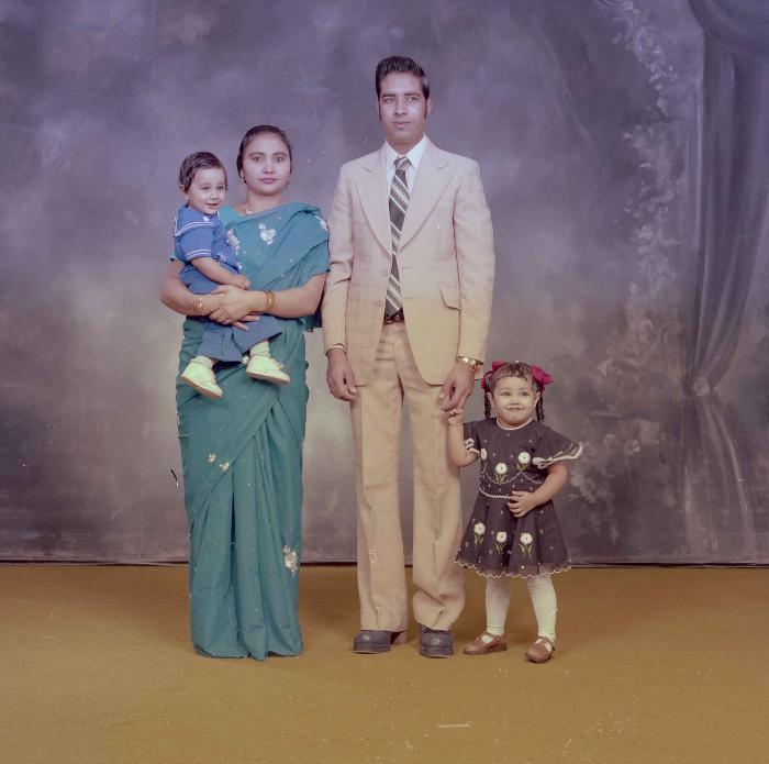 [Photo of Hardev Sandhu with family members]