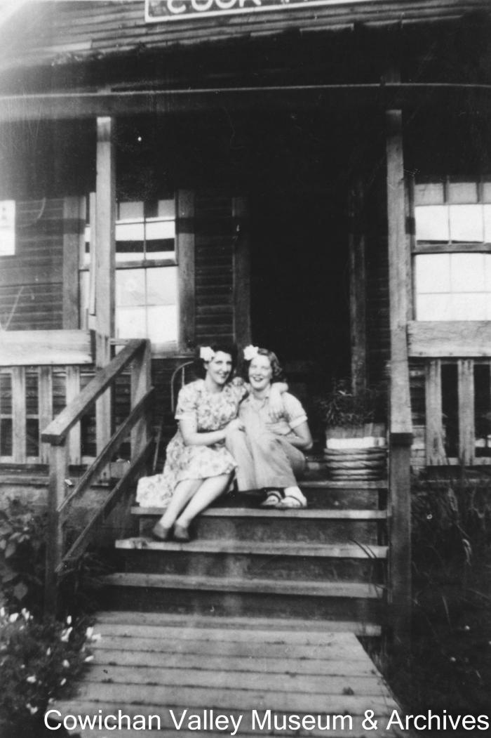 Pat and Joyce Stubbs on steps of cookhouse run by their parents