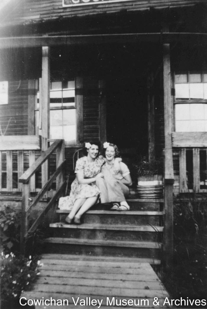 Joyce and Pay [sic.] Stubbs on steps of cookhouse near brother's parents