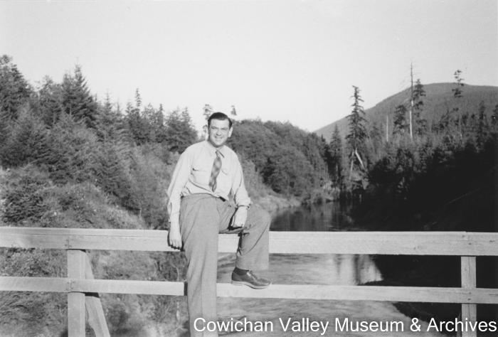 [A man posing on a bridge]