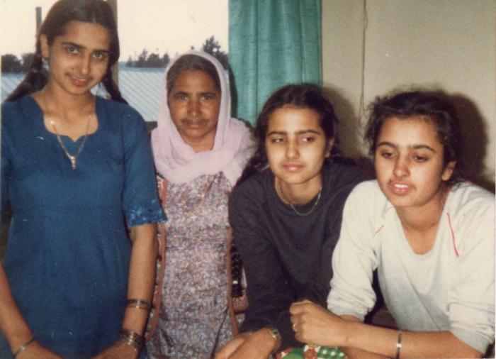 [Photo of Surjit Kaur and her three daughters]