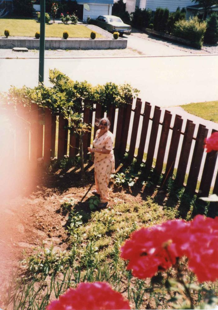 [Photo of Surjit Kaur in her backyard garden]