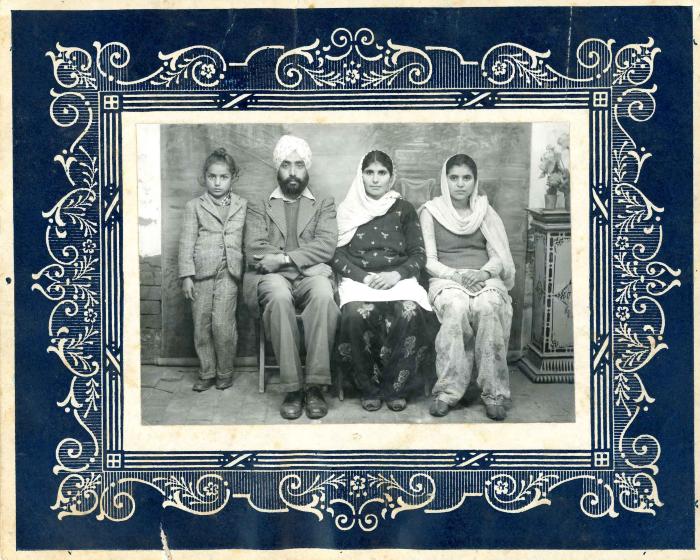 [Studio photograph of Mohinder Singh Atwal, two unidentified women, and a child]