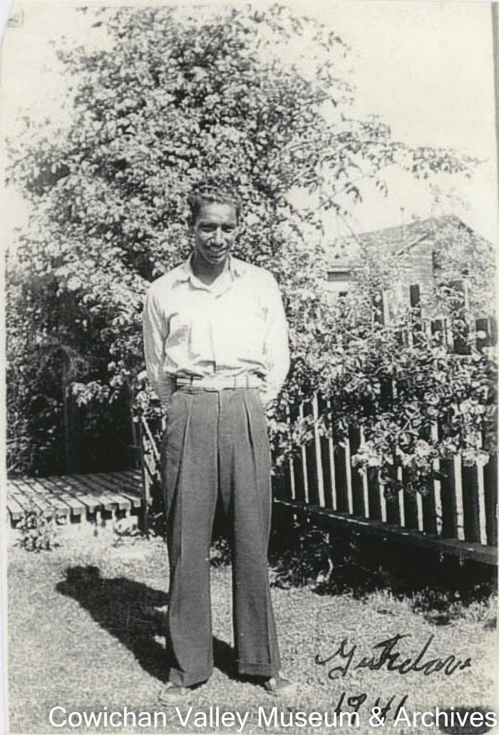 [A man posing in a yard]