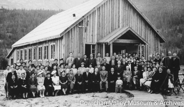 [Japanese Canadians in front of the community center they built while incarcerated]