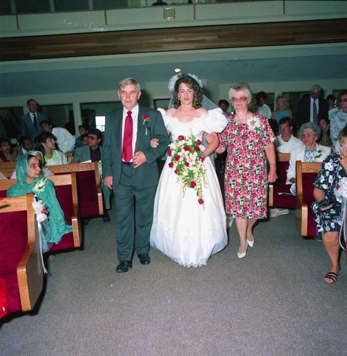 [Photo of Leanne Neitch with her parents in the church]