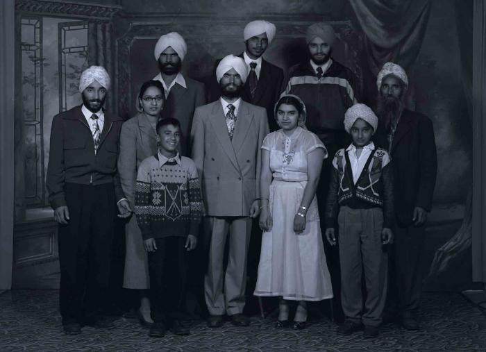 [Photo of Gurbachan Singh with wife and family members]