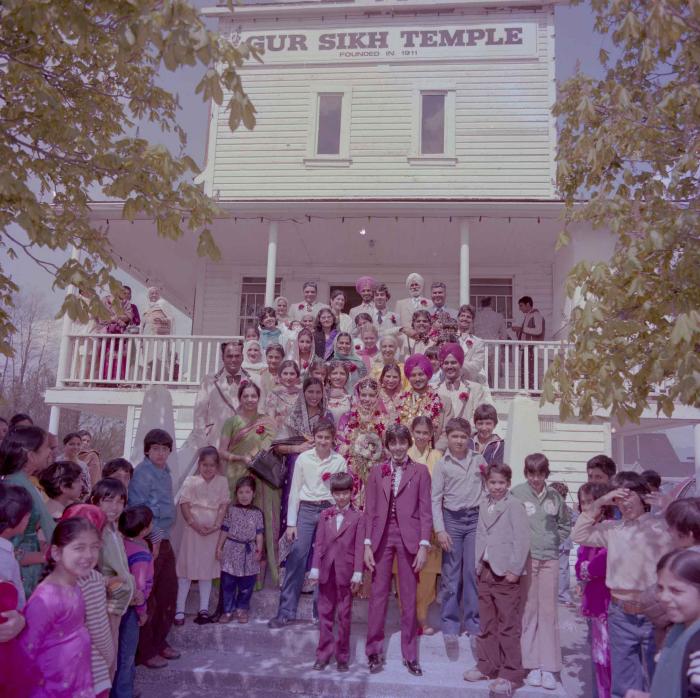 [Photo of Baljit Sidhu and Inderjit Gill with family members]