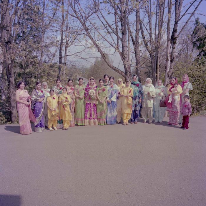 [Photo of Inderjit Gill with unidentified women]