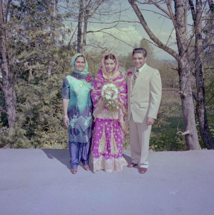 [Photo of Inderjit Gill with unidentified individuals]