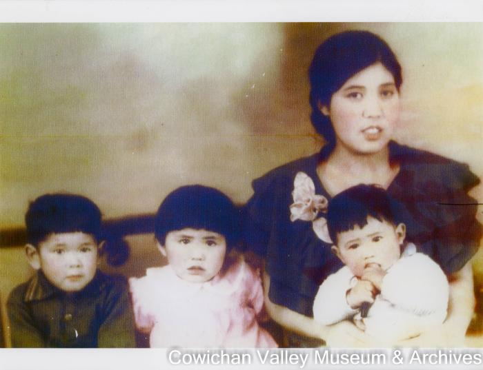 [A woman and three children posing for a family photo]