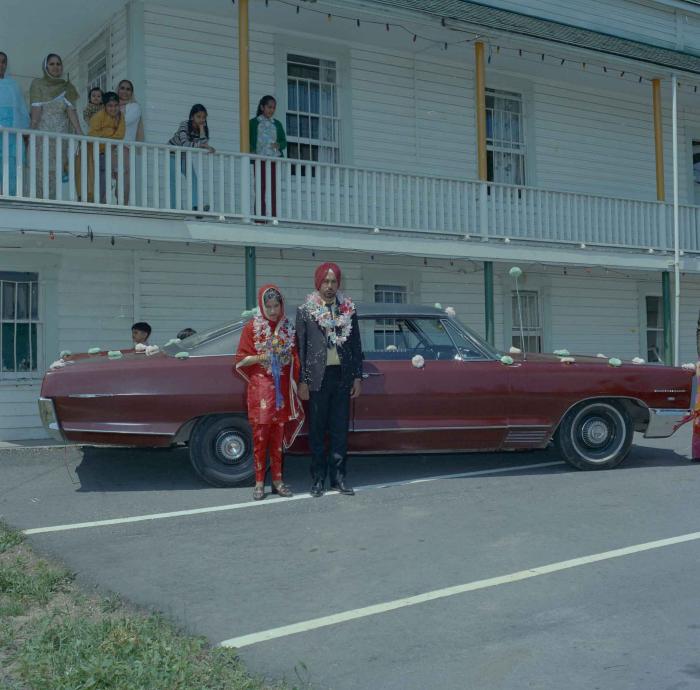 [Photo of an unidentified groom with an unidentified bride]