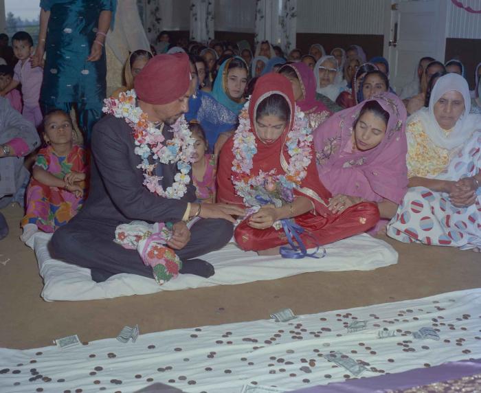 [Photo of an unidentified groom with an unidentified bride]