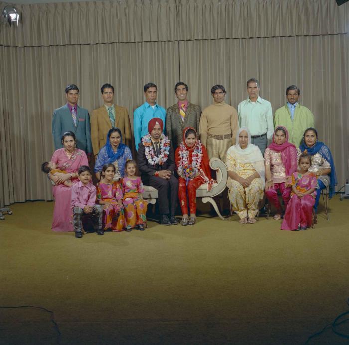 [Photo of an unidentified groom with an unidentified bride]