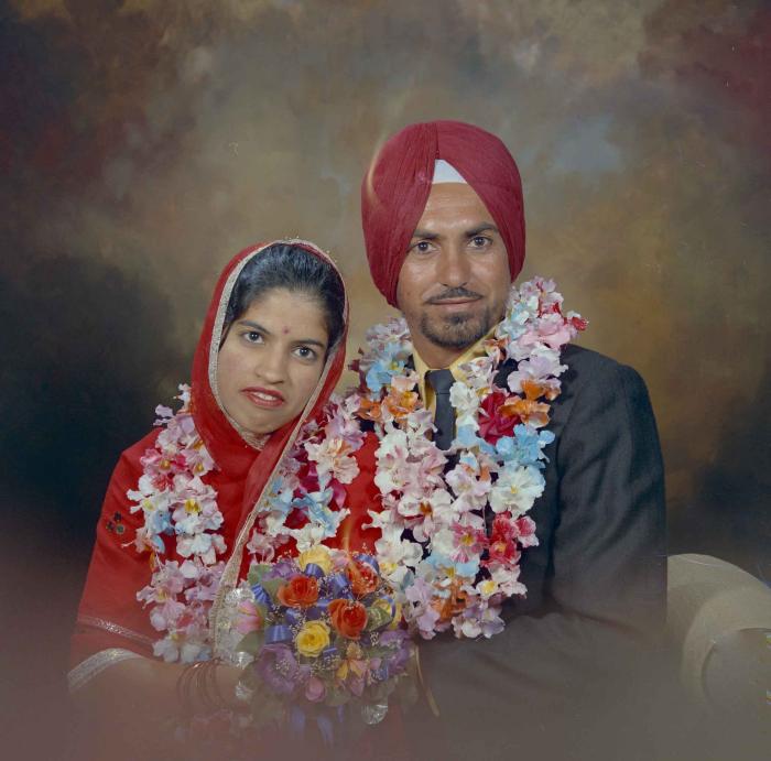 [Photo of an unidentified groom with an unidentified bride]