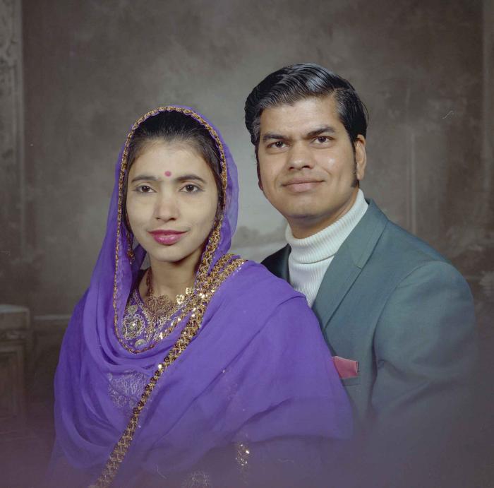 [Photo of Sukhdarshan Singh Gill with an unidentified woman]