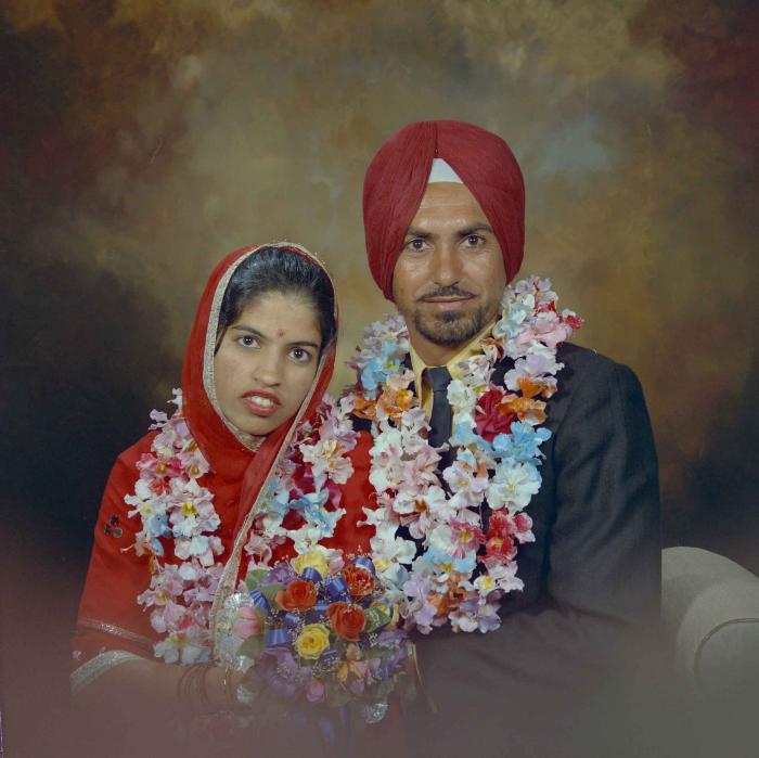 [Photo of an unidentified groom with an unidentified bride]