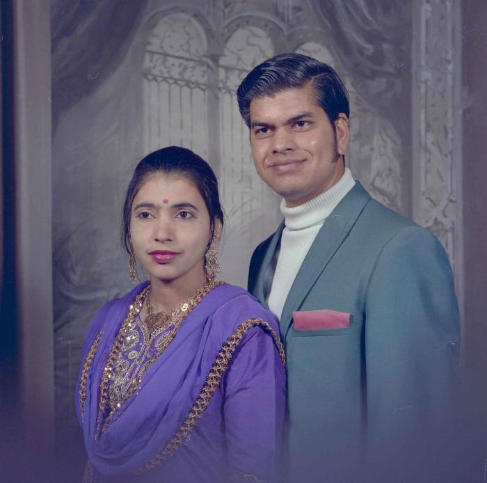 [Photo of Sukhdarshan Singh Gill with an unidentified woman]