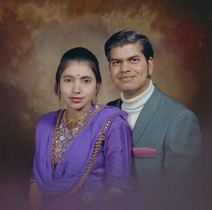 [Photo of Sukhdarshan Singh Gill with an unidentified woman]