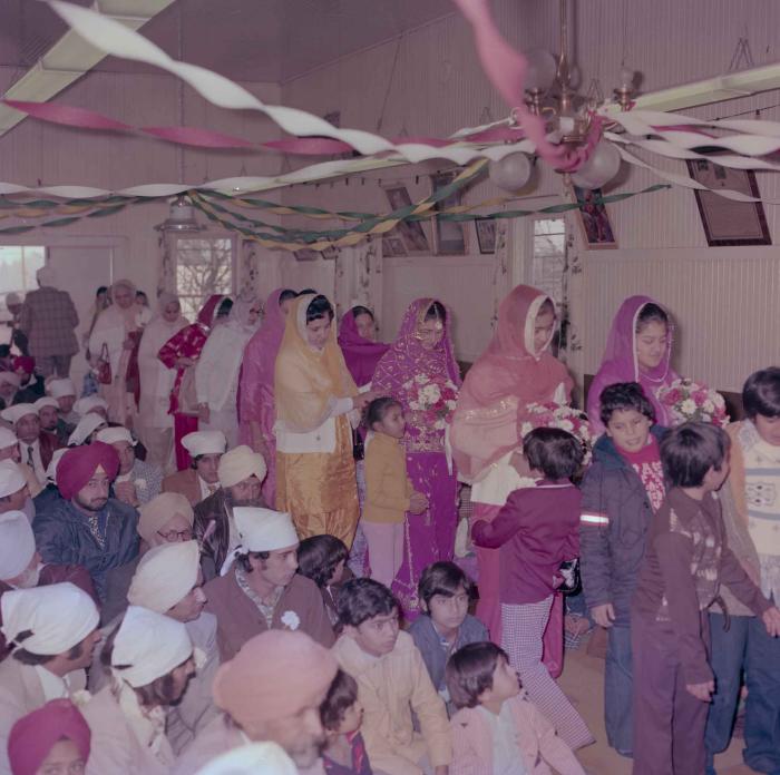 [Group photo of Rupinder Mann with wedding guests]