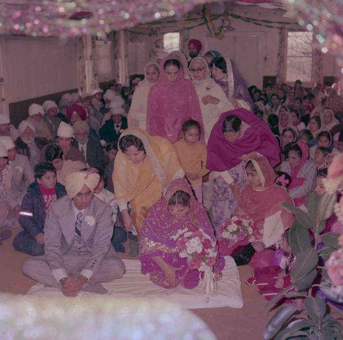 [Group photo of Vern Thind and Rupinder Mann with wedding guests]