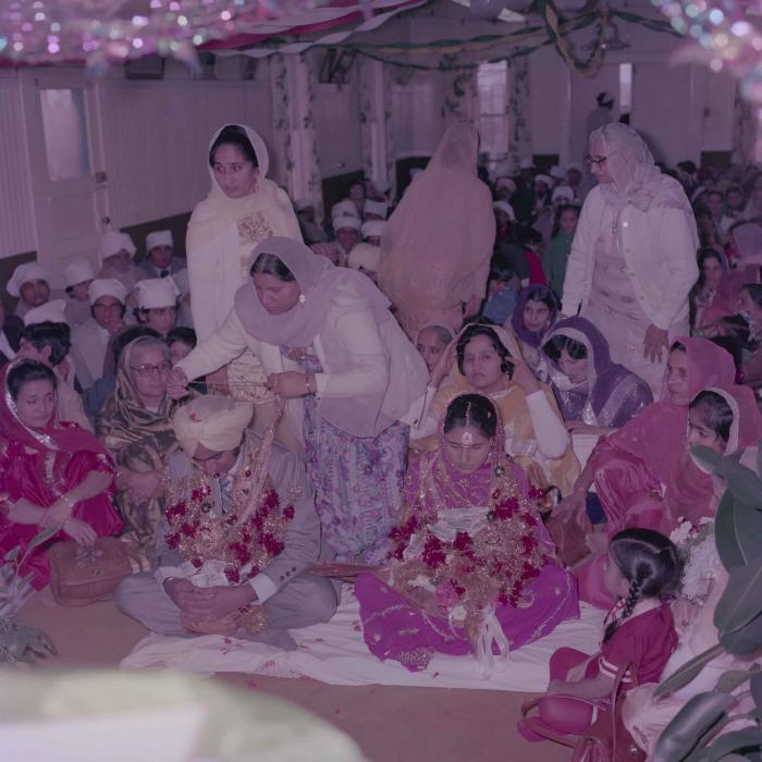 [Group photo of Vern Thind and Rupinder Mann with wedding guests]
