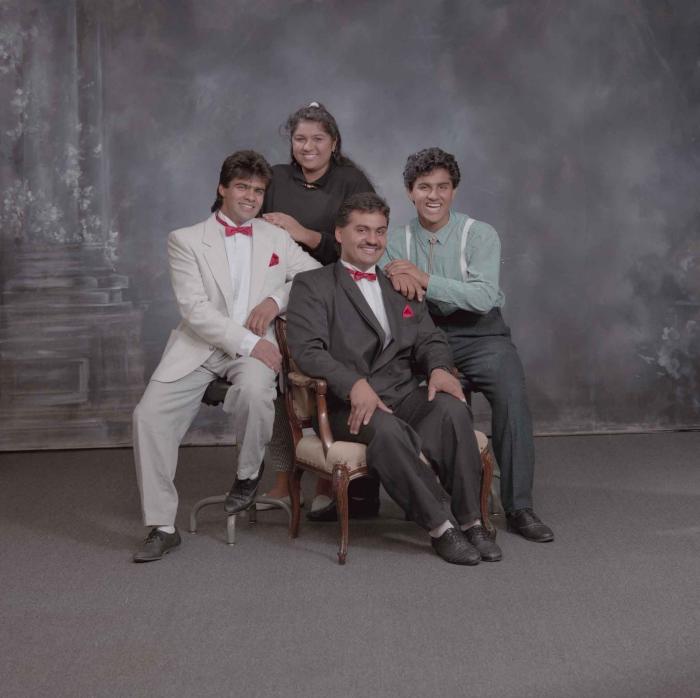 [Group photo of Pam Thind with three unidentified individuals]