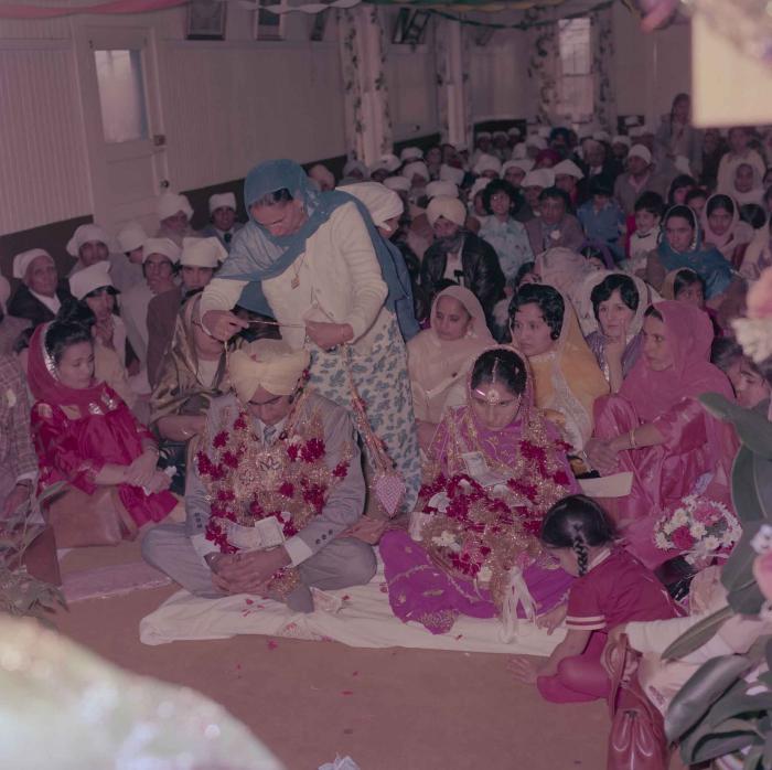 [Group photo of Vern Thind and Rupinder Mann with wedding guests]