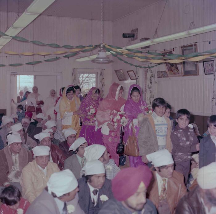 [Group photo of Rupinder Mann with wedding guests]