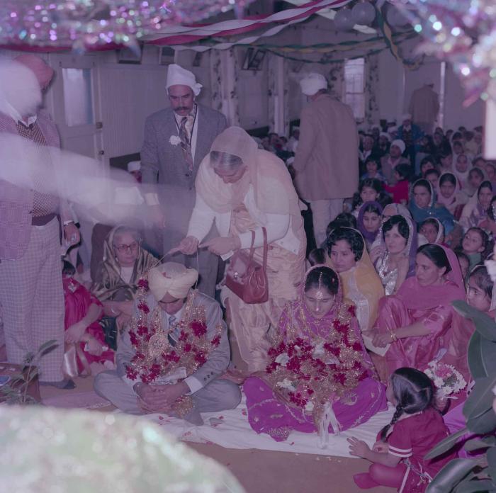 [Group photo of Vern Thind and Rupinder Mann with wedding guests]