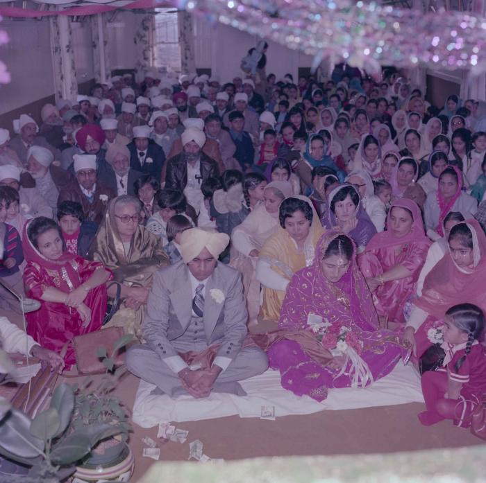 [Group photo of Vern Thind and Rupinder Mann with wedding guests]