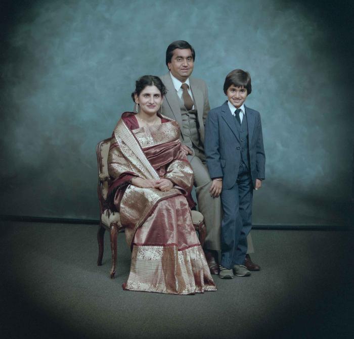 [Group photo of Vern Thind, Rupinder Mann, and their son]