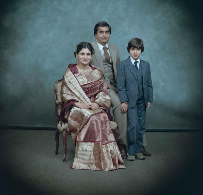 [Group photo of Vern Thind, Rupinder Mann, and their son]
