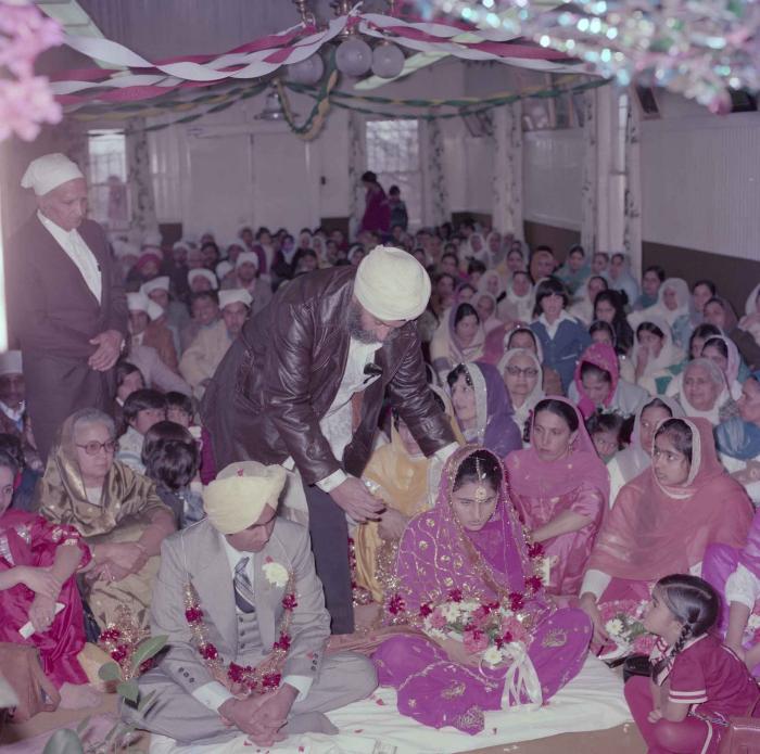 [Group photo of Vern Thind and Rupinder Mann with wedding guests]