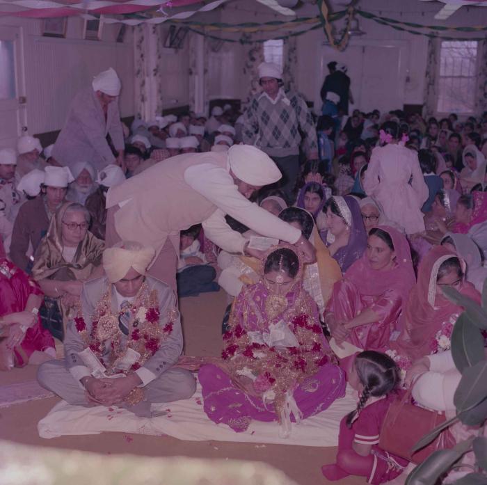 [Group photo of Vern Thind and Rupinder Mann with wedding guests]