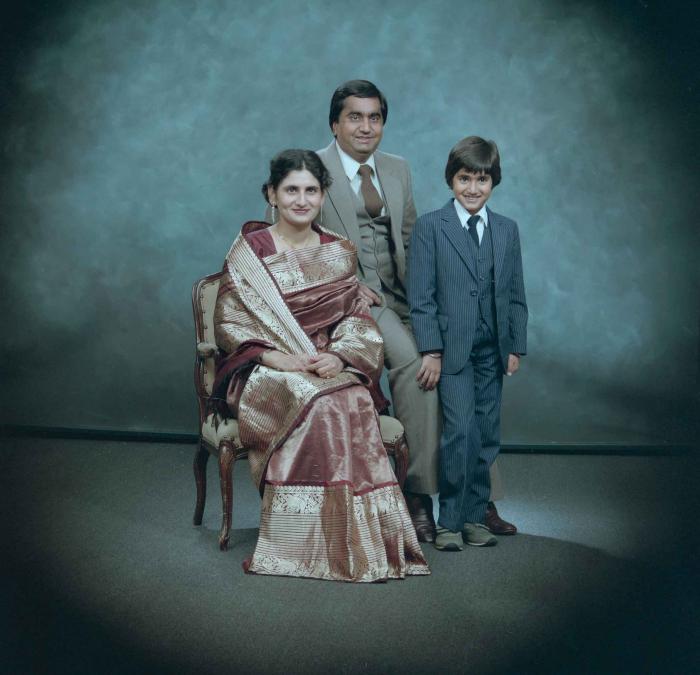 [Group photo of Vern Thind, Rupinder Mann, and their son]